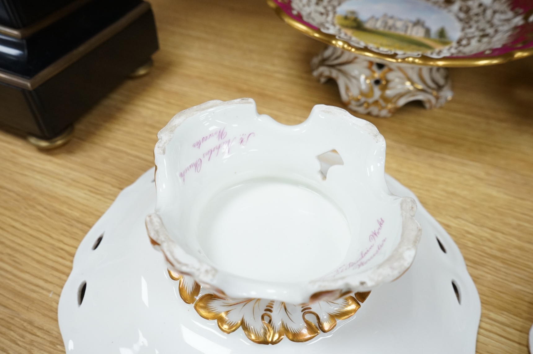 Four G Grainger, Worcester armorial porcelain comports, c.1845, hand painted with named views of Worcester, 24cm in diameter